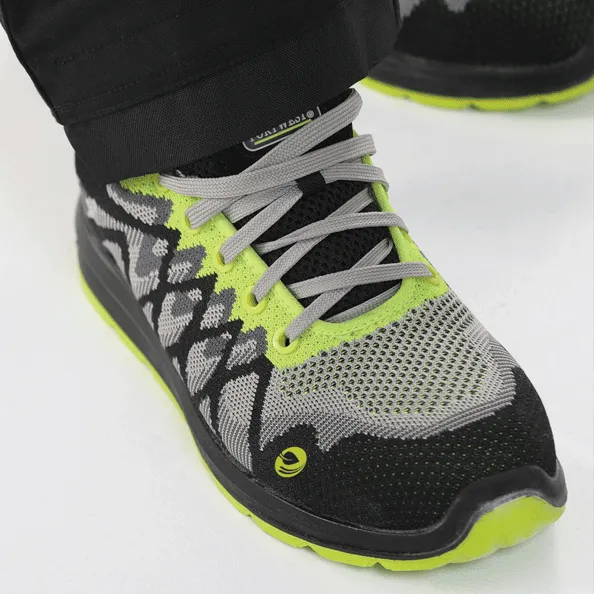 Close-up sepatu safety Portwest model sporty berwarna hitam dan hijau neon, memberikan perlindungan kaki yang aman dan nyaman untuk pekerja.